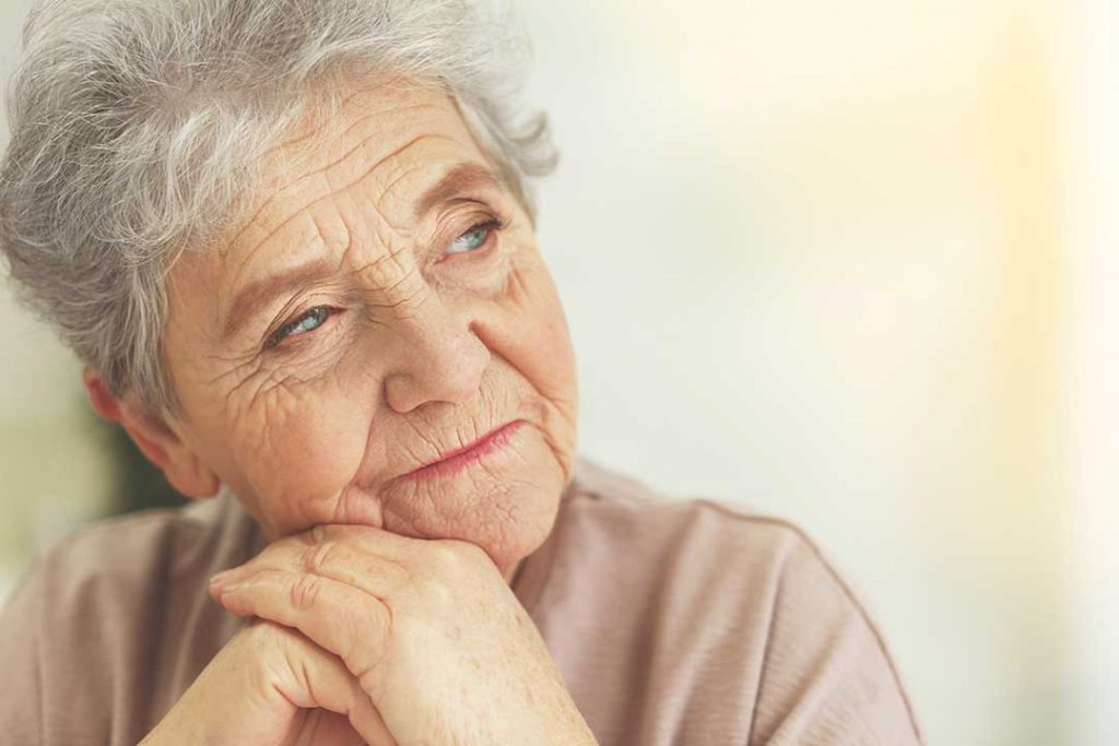 Elderly woman contemplating